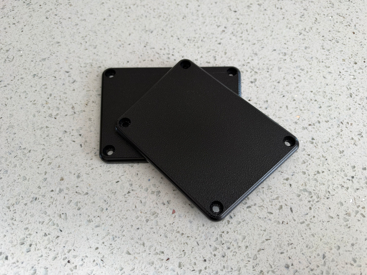 Two Hobie Pro Angler Rod Tube Delete Plates stacked, 1/4 inch black Starboard HDPE, rounded corners with four mounting holes